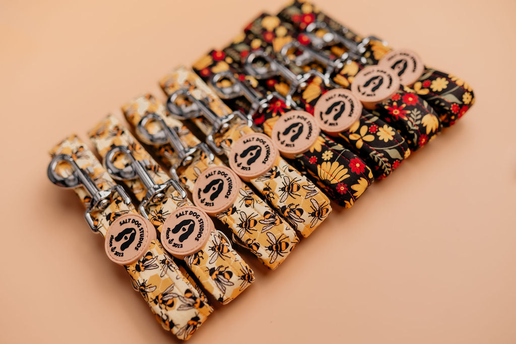 A selection of hand designed fabric dog leads displayed together showing various patterns and colours