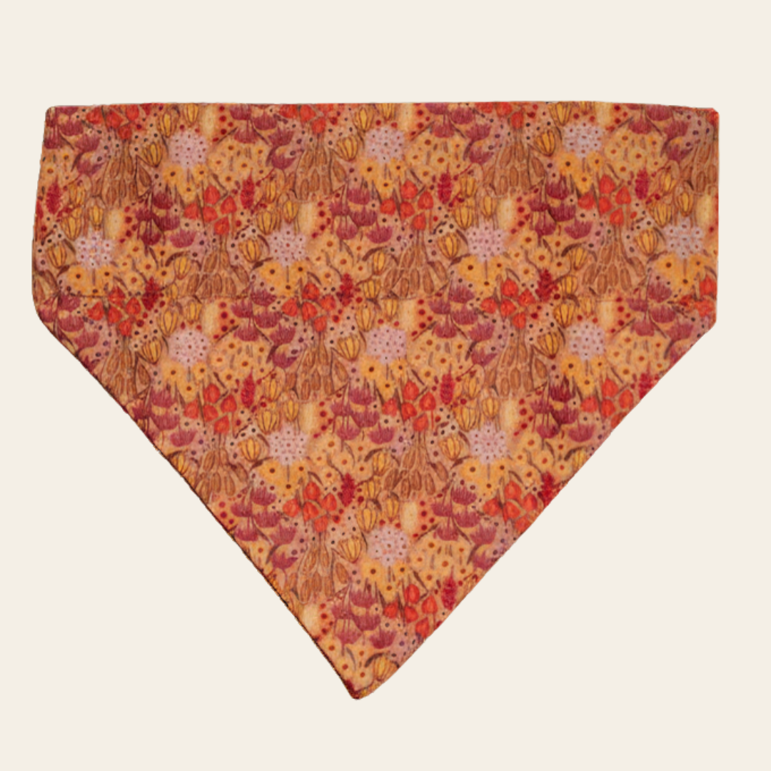 Wildflower Meadow dog bandana with pink and gold floral print, shown flat