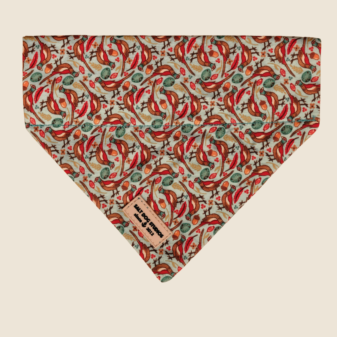 Pheasants dog bandana with red and green pheasant print, shown flat