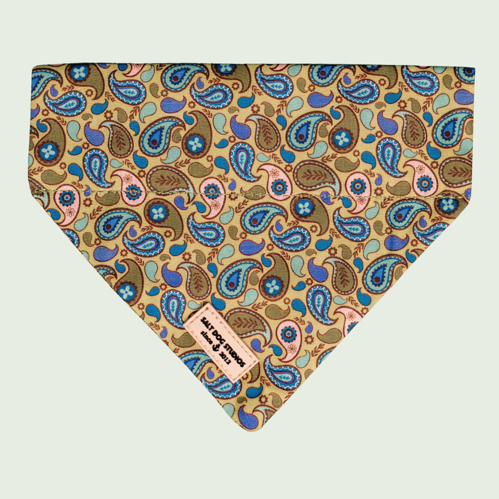Paisley dog bandana with blue, green and yellow paisley print, shown flat