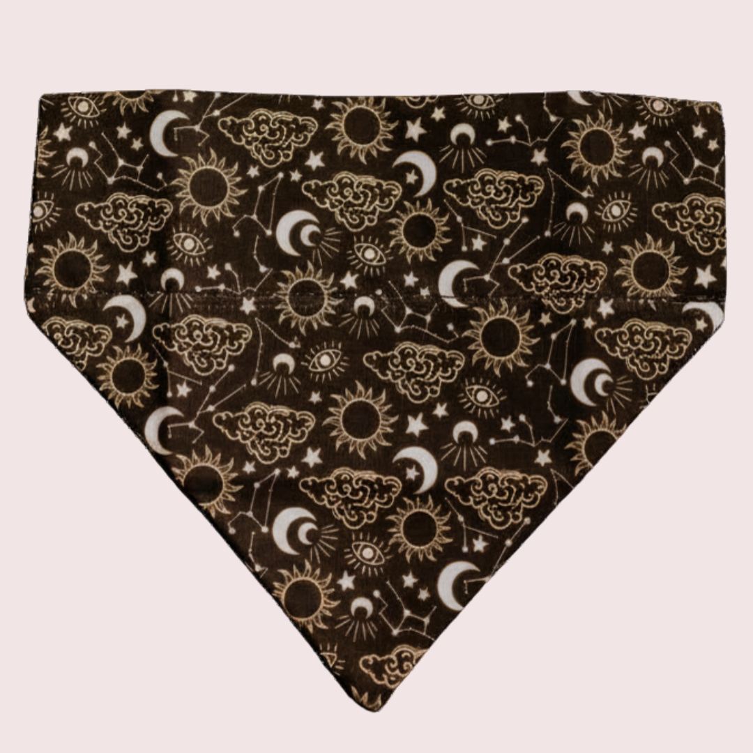 Celestial dog bandana with gold suns, moons and stars on black, shown flat