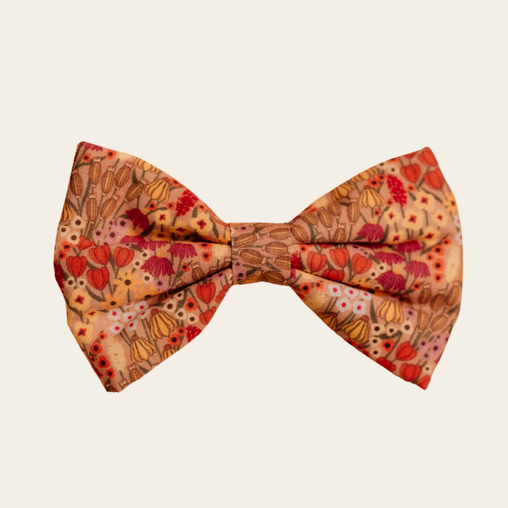 Wildflower Meadow dog bow tie with pink and gold floral print, front view