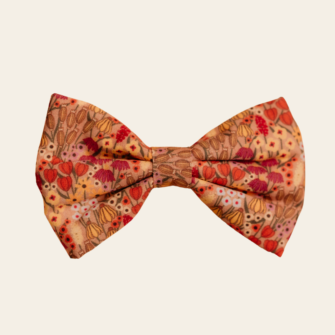 Wildflower Meadow dog bow tie with pink and gold floral print, front view