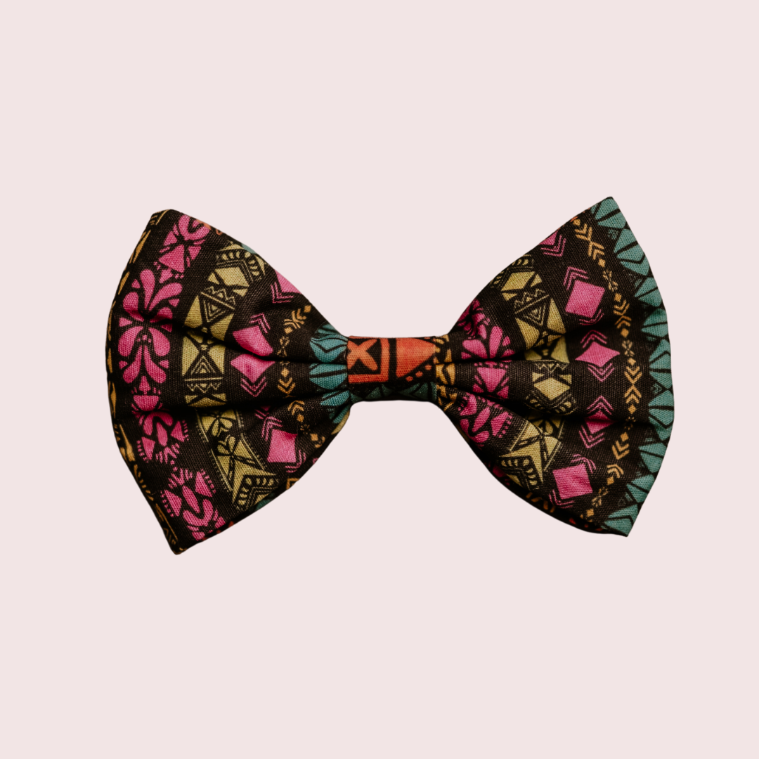 Retro Tribal dog bow tie with pink and teal geometric print on black, front view