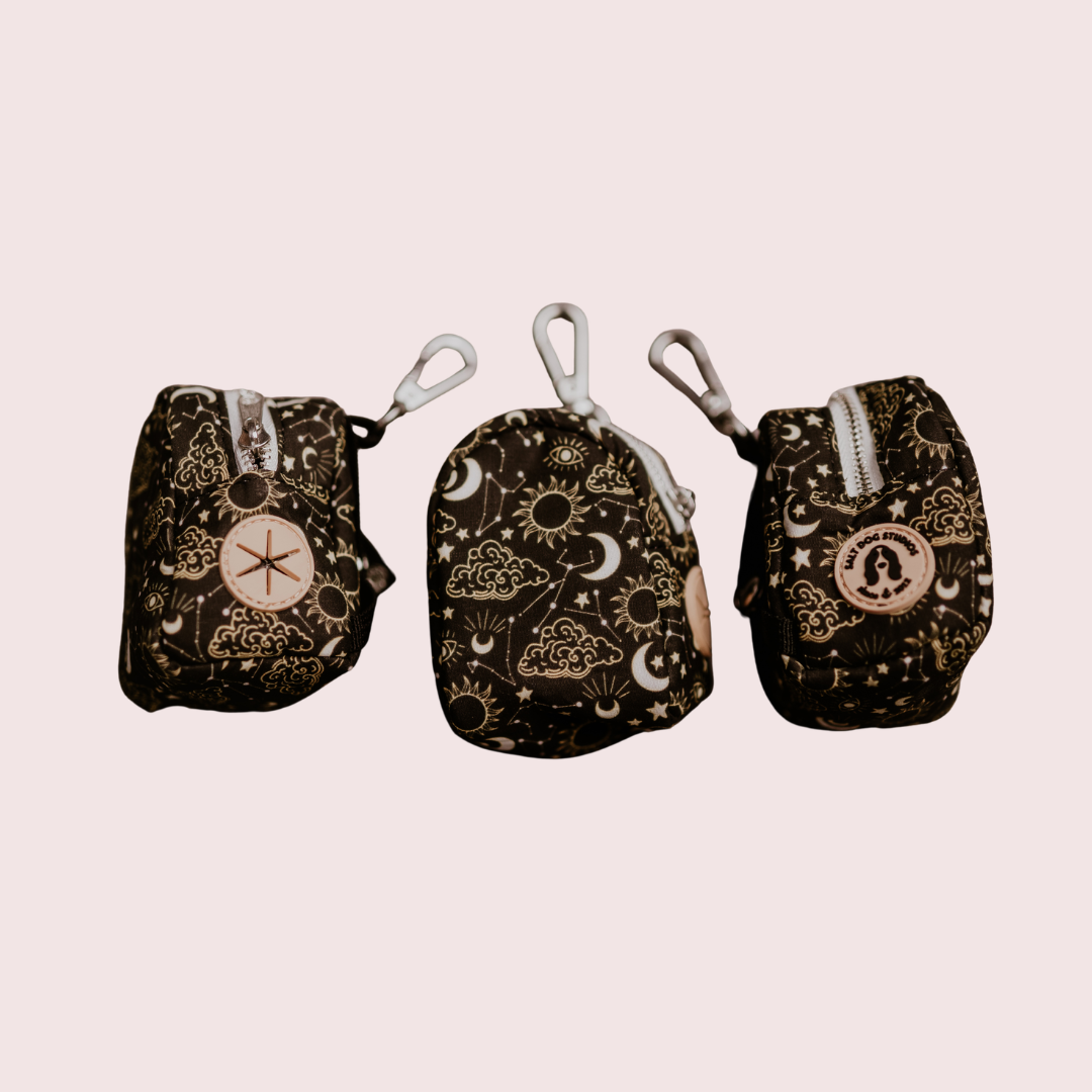 Celestial dog poo bag holder with gold suns, moons and stars on black, shown from three angles