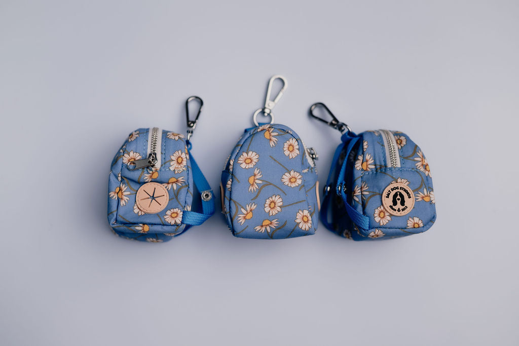 Blue daisy print dog poo bag holder with clip and side dispenser — matches Daisy Daisy accessories by Salt Dog Studios.
