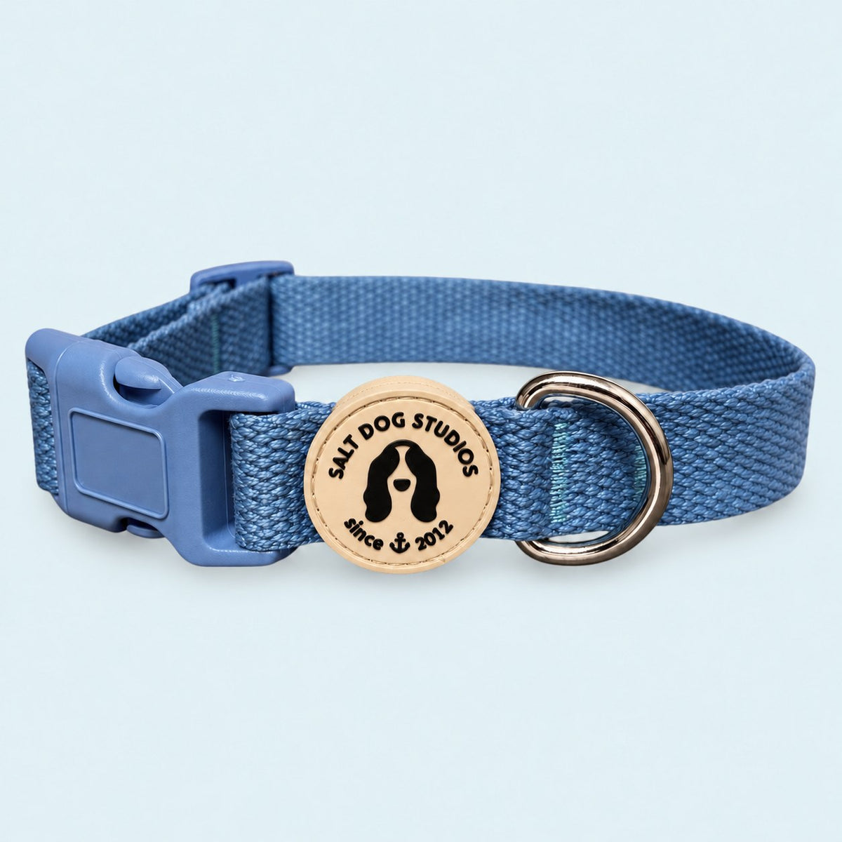 Salt Dog Studios plain cornflower blue hemp dog collar, matching buckle and metal D-ring on a pale blue background.