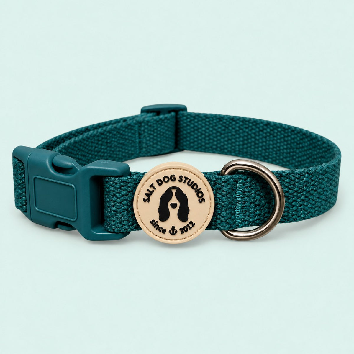 Salt Dog Studios plain dark teal hemp dog collar, matching buckle and metal D-ring on a pale mint green background.