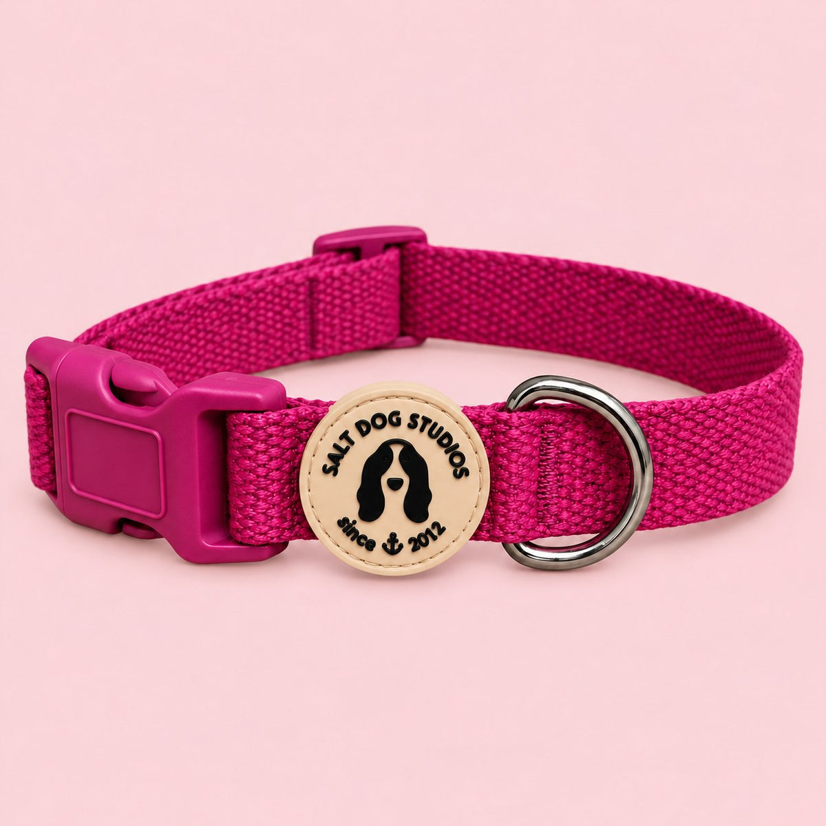 Salt Dog Studios plain magenta pink hemp dog collar, matching buckle and metal D-ring on a rose blush background.