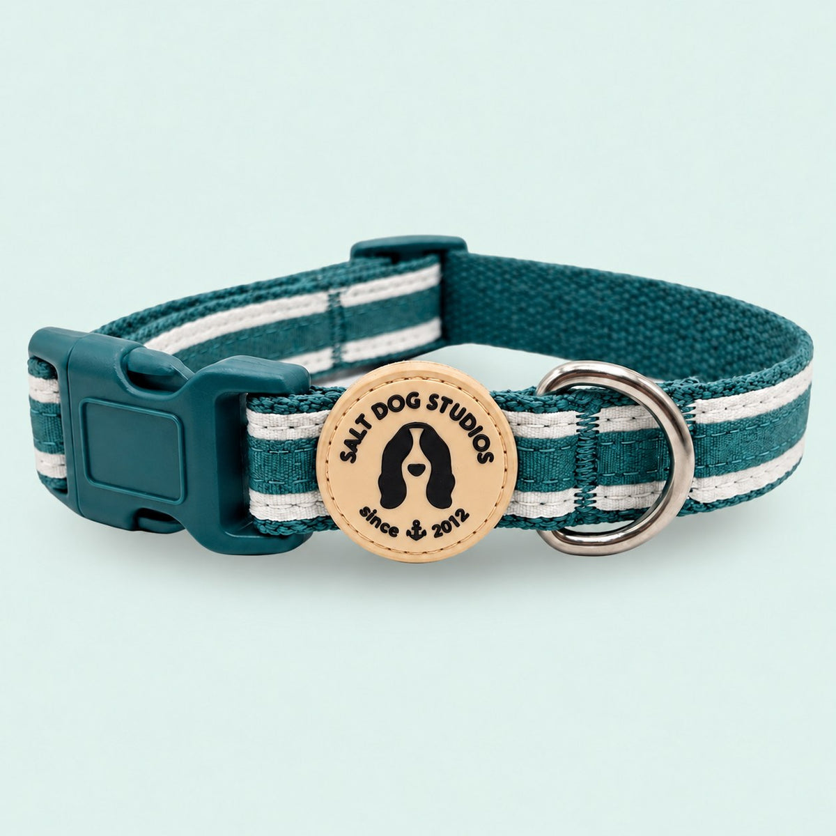 Salt Dog Studios striped dark teal hemp dog collar with white ribbon stripes, matching buckle and metal D-ring on a pale mint green background.