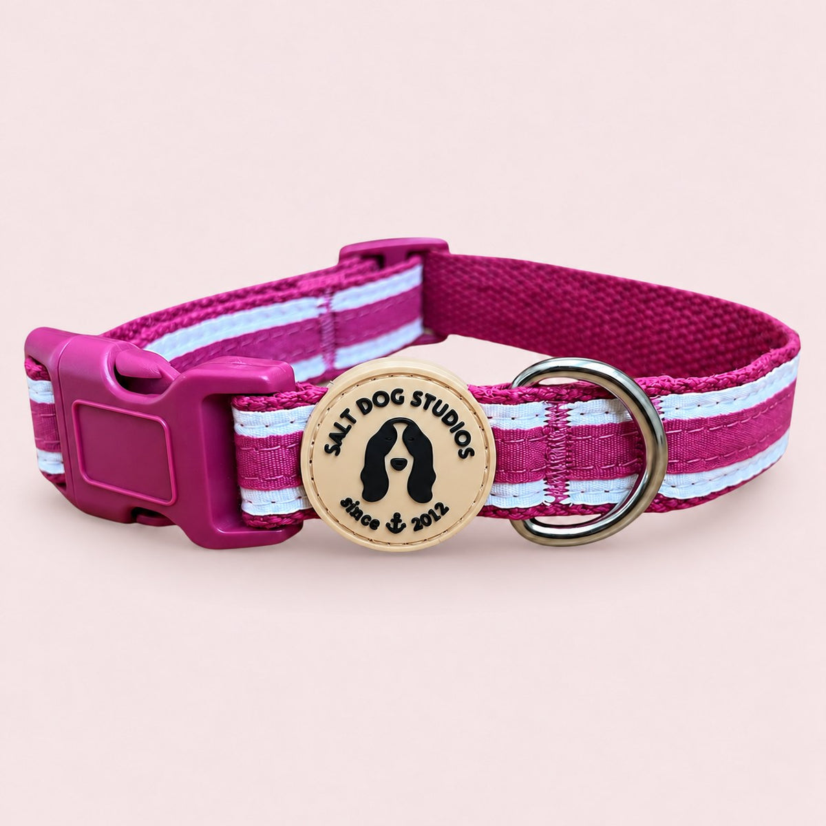 Salt Dog Studios striped magenta pink hemp dog collar with white ribbon stripes, matching buckle and metal D-ring on a rose blush background.