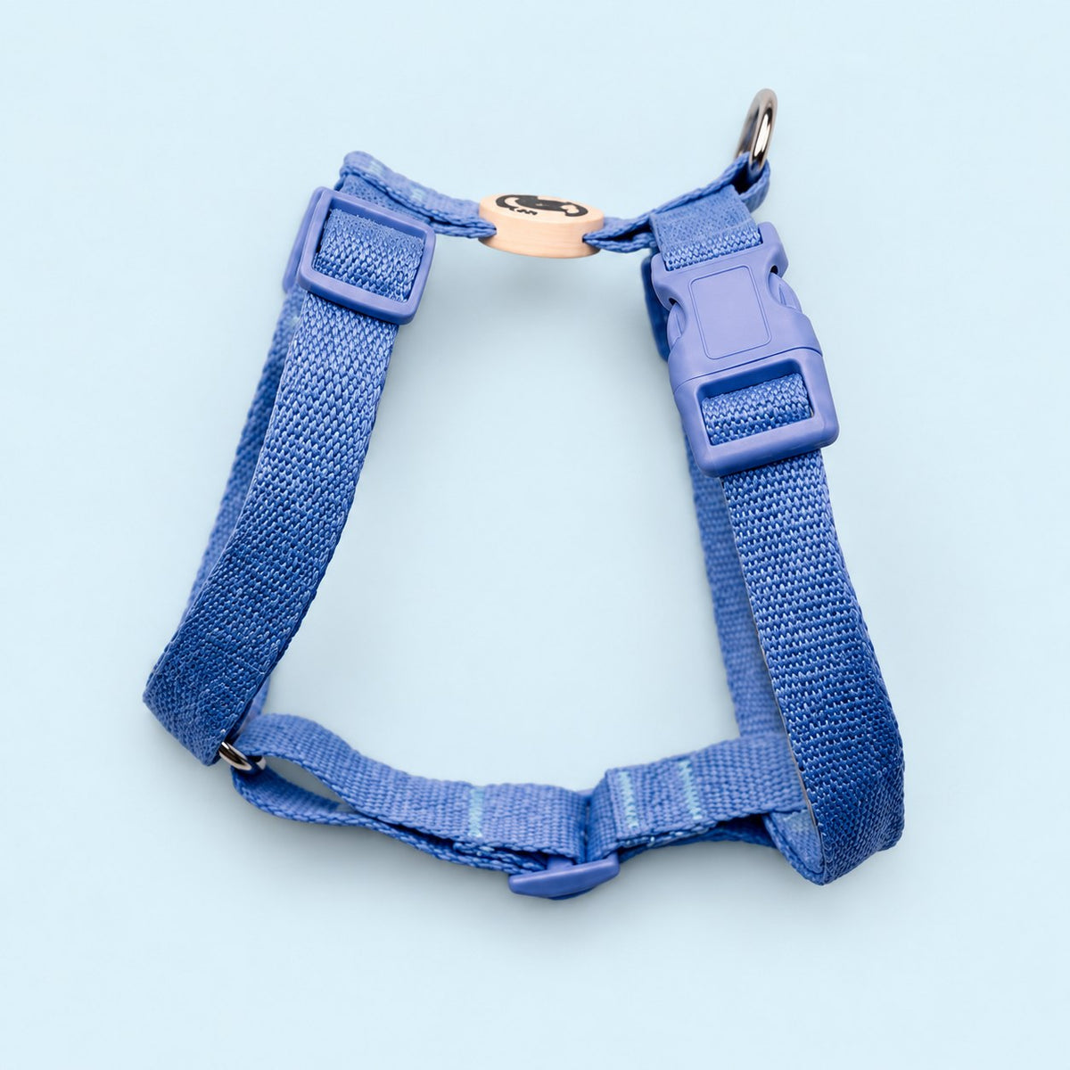 Salt Dog Studios plain cornflower blue hemp dog harness with adjustable straps and matching buckle on a pale blue background.