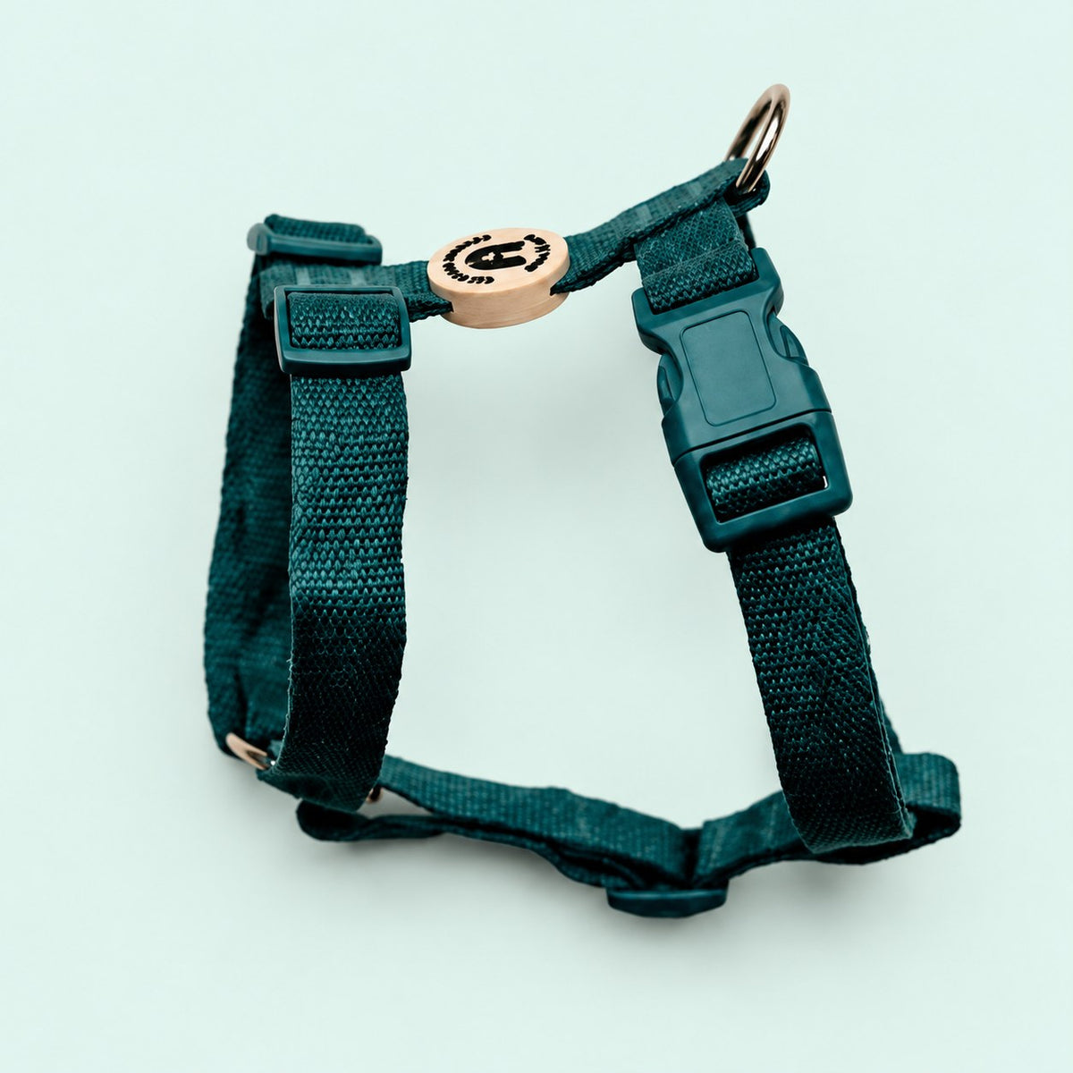 Salt Dog Studios plain dark teal hemp dog harness with adjustable straps and matching buckle on a pale mint green background.