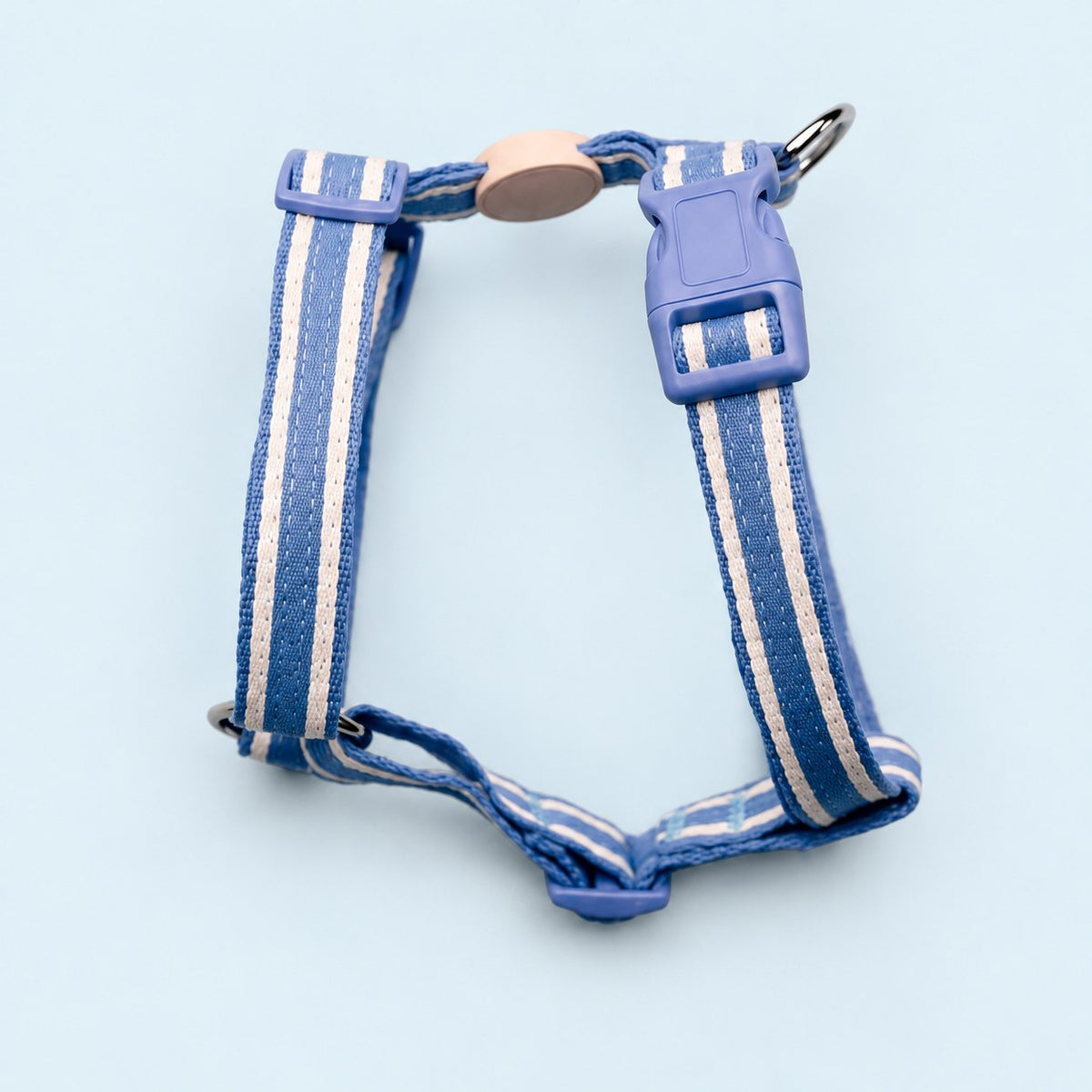 Salt Dog Studios striped cornflower blue hemp dog harness with adjustable straps and matching buckle, with white ribbon stripes on a pale blue background.