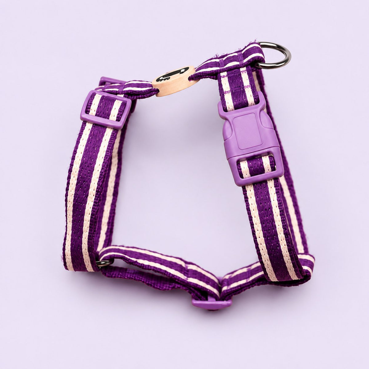 Salt Dog Studios striped indigo purple hemp dog harness with adjustable straps and matching buckle, with white ribbon stripes on a pale lavender background.