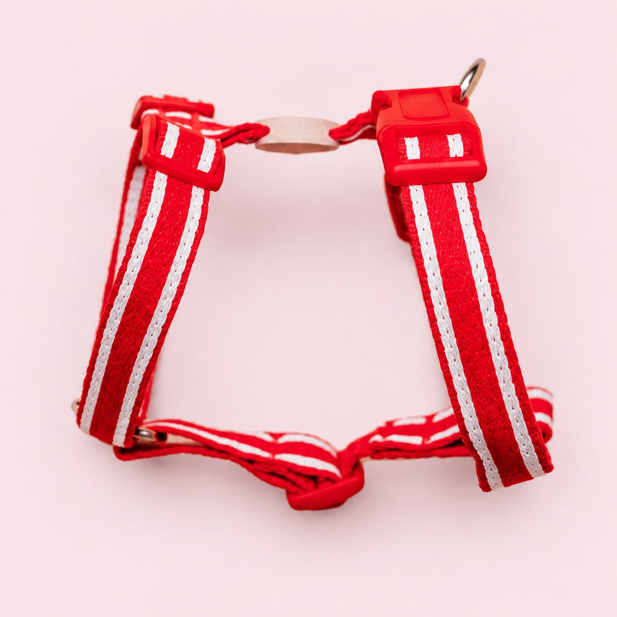 Salt Dog Studios striped scarlet red hemp dog harness with adjustable straps and matching buckle, with white ribbon stripes on a rose blush background.