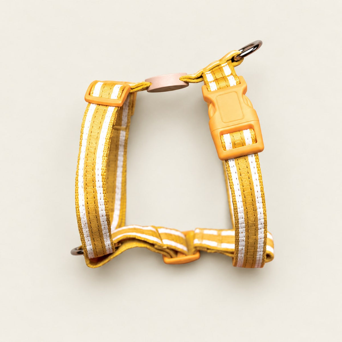 Salt Dog Studios striped sunflower yellow hemp dog harness with adjustable straps and matching buckle, with white ribbon stripes on a pale beige background.