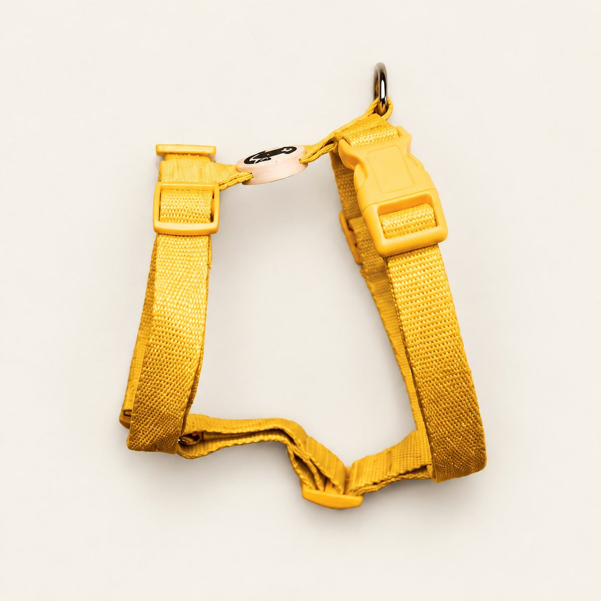 Salt Dog Studios plain sunflower yellow hemp dog harness with adjustable straps and matching buckle on a pale beige background.