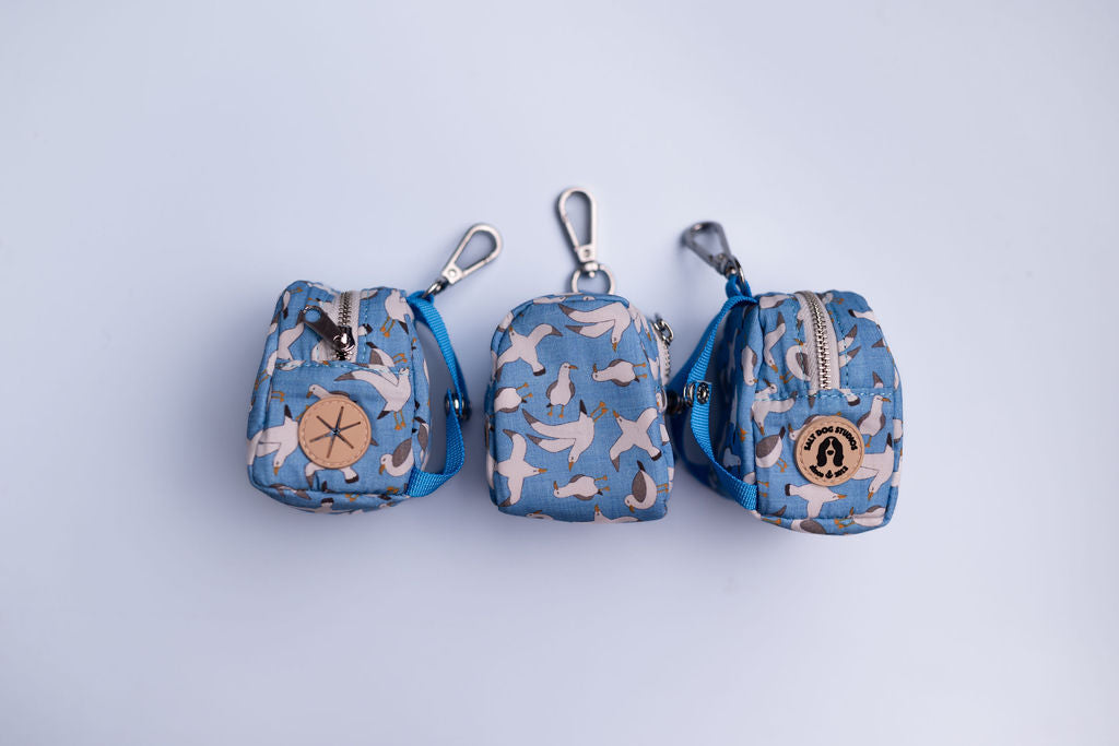 Seagulls Poo Bag Holder by Salt Dog Studios — blue seaside design with white seagulls, zip closure, and poo bag dispenser.
